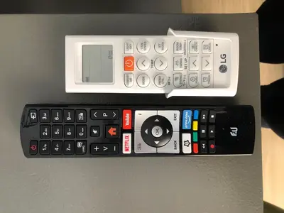 a group of remote controls sitting on top of a table at Metropolitan Complex Suite Faliro in Piraeus