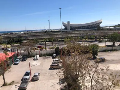 a parking lot with cars parked in front of a building at Metropolitan Complex Suite Faliro in Piraeus