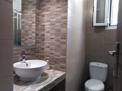 a bathroom with a sink and a toilet at Piraeus Suite~Ermioni Villas in Piraeus