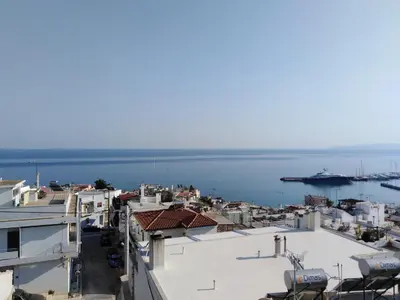 a view of a city with a ship in the water at Piraeus Suite~Ermioni Villas in Piraeus