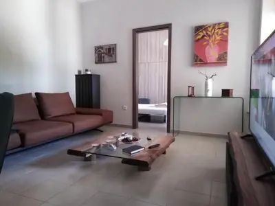 a living room with a couch and a coffee table at Piraeus Suite~Ermioni Villas in Piraeus