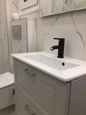 a white bathroom with a sink and a toilet at Patision Avenue, Apartment with Two bedrooms in Athens