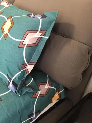 a green pillow with a design on it on a couch at Patision Avenue, Apartment with Two bedrooms in Athens