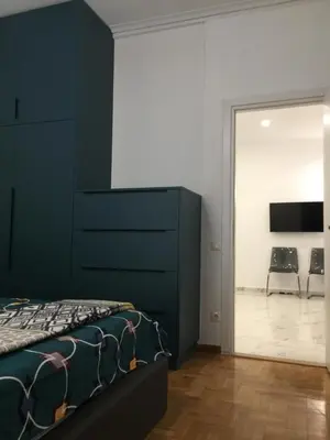 a bedroom with a bed and a sliding glass door at Patision Avenue, Apartment with Two bedrooms in Athens