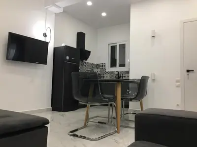 a living room with a table and chairs at Patision Avenue, Apartment with Two bedrooms in Athens