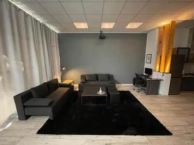 a living room with a couch and a table at Cinema Zeus Studios - by Avelink in Spáta