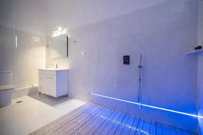 a bathroom with a shower and a sink and a tub at Cinema Zeus Studios - by Avelink in Spáta