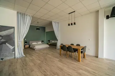 a room with a table and chairs and a bed at Cinema Zeus Studios - by Avelink in Spáta