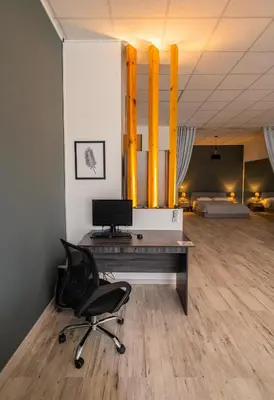 a office with a desk and a chair in a room at Cinema Zeus Studios - by Avelink in Spáta