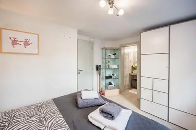 a bedroom with a bed and a closet at Glyfadas Luxury Design Apartments in Athens