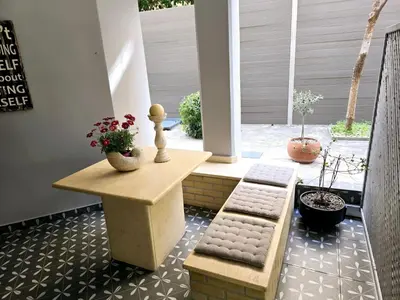 a patio with two chairs and a table with flowers at Glyfadas Luxury Design Apartments in Athens