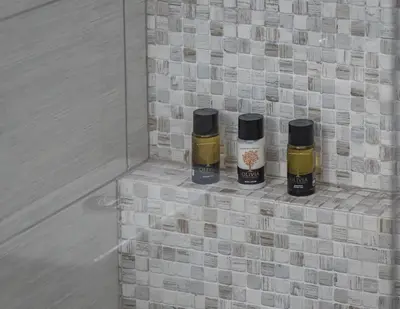 three bottles of honey sitting on a tile wall at Glyfadas Luxury Design Apartments in Athens