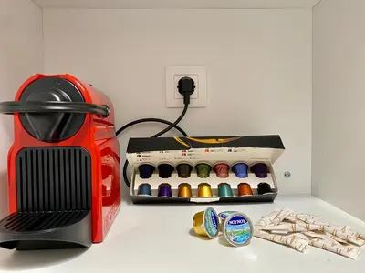 a table with a sewing machine and a box of pens at For a genuine Athenian homestay! in Athens