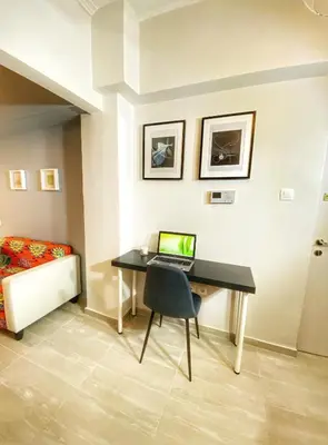a bedroom with a desk with a laptop on it at For a genuine Athenian homestay! in Athens