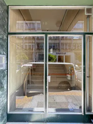 a reflection of a building in a glass window at Melodies of Athens apt in Ilisia neighbourhood in Athens