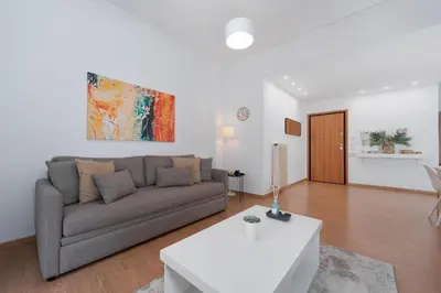 a living room with a couch and a table at Melodies of Athens apt in Ilisia neighbourhood in Athens