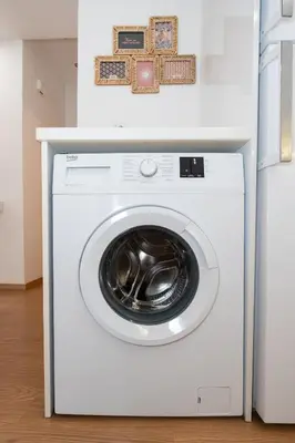 a white washing machine sitting next to a refrigerator at Melodies of Athens apt in Ilisia neighbourhood in Athens