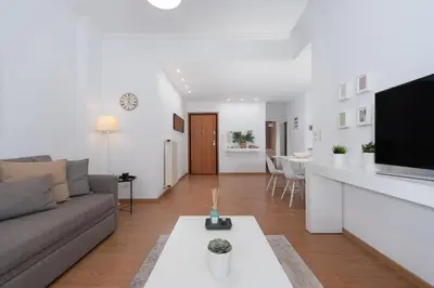 a living room with a couch and a table at Melodies of Athens apt in Ilisia neighbourhood in Athens