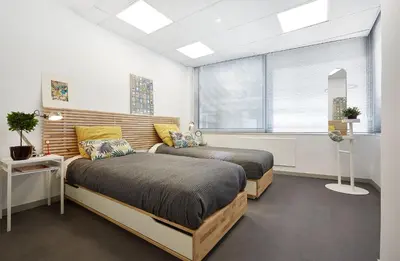 a bedroom with two beds and a window at Chloe Boutique Apartments Apollo in Athens