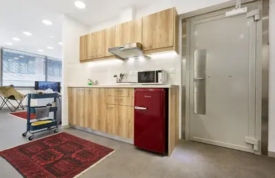 a kitchen with a red refrigerator and wooden cabinets at Chloe Boutique Apartments Apollo in Athens