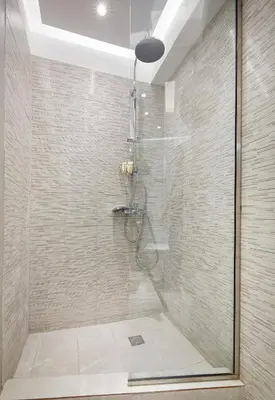 a bathroom with a shower with a glass door at Chloe Boutique Apartments Apollo in Athens