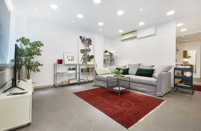 a living room with a couch and a television at Chloe Boutique Apartments Apollo in Athens