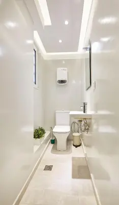 a white bathroom with a toilet and a sink at Chloe Boutique Apartments Apollo in Athens