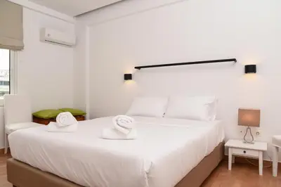 a bedroom with a large white bed with two towels on it at HOTEL_TIER in Athens