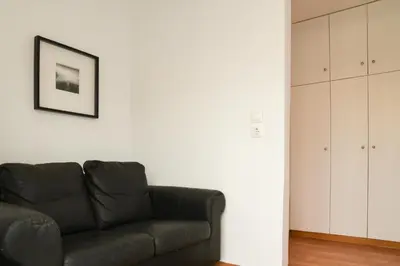 a living room with a couch and a picture on the wall at HOTEL_TIER in Athens