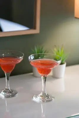 two martini glasses sitting on a table with a drink at HOTEL_TIER in Athens
