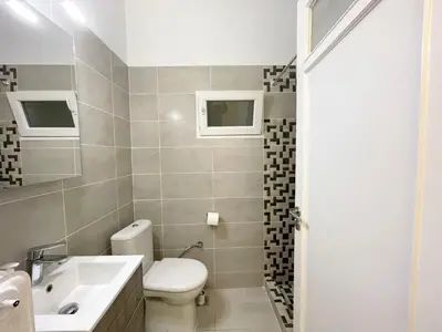 a bathroom with a toilet and a sink at Faliro Apartments Next To The Beach in Athens