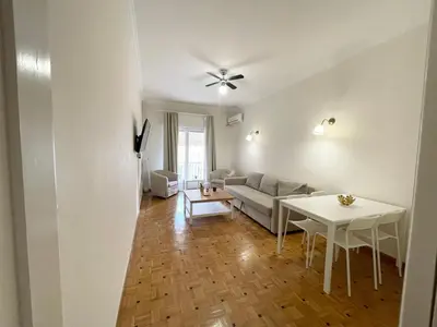 a living room with a couch and a table at Faliro Apartments Next To The Beach in Athens