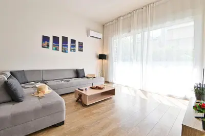 a living room with a couch and a table at Thisean Modern Suites By Athens Stay in Athens
