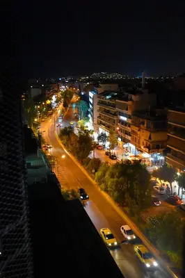 a city at night with cars driving down a street at Thisean Modern Suites By Athens Stay in Athens