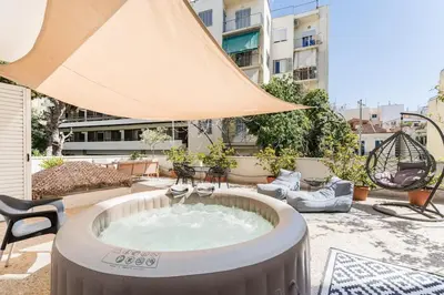 a hot tub in the middle of a patio at Amazing 3BDR Apt with Unique Roof Garden in Plaka in Athens