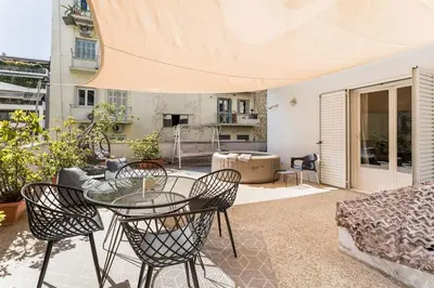a patio with a glass table and chairs at Amazing 3BDR Apt with Unique Roof Garden in Plaka in Athens