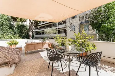a patio with a glass table and chairs at Amazing 3BDR Apt with Unique Roof Garden in Plaka in Athens