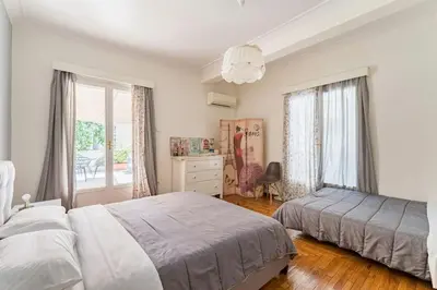 a bedroom with two beds and a window at Amazing 3BDR Apt with Unique Roof Garden in Plaka in Athens