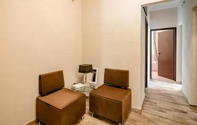 two chairs in a room with a table and a television at Amazing House with Jacuzzi and Huge PVT Garden in Athens