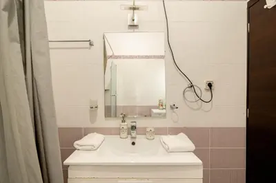 a bathroom with a sink and a mirror at Amazing House with Jacuzzi and Huge PVT Garden in Athens