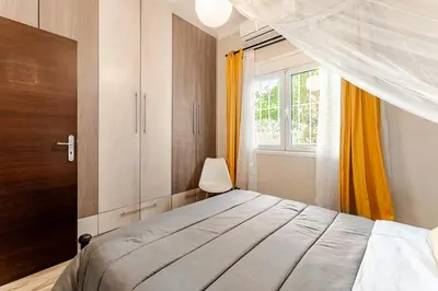 a bedroom with a bed and a window at Amazing House with Jacuzzi and Huge PVT Garden in Athens