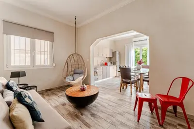 a living room with a couch and a table at Amazing House with Jacuzzi and Huge PVT Garden in Athens