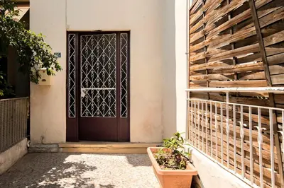 a door to a house with a plant in front at Amazing House with Jacuzzi and Huge PVT Garden in Athens