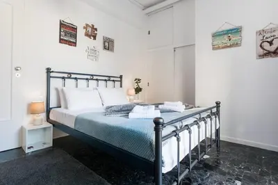 a bedroom with a bed in a white room at A Masterpiece in Plaka with Big Balcony and Acropolis View in Athens