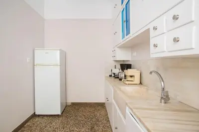 a kitchen with white cabinets and a white refrigerator at Splendid Full 5BDR/3bath/2kitchens Mansion in ATH in Athens