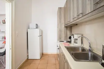 a kitchen with a sink and a refrigerator at Splendid Full 5BDR/3bath/2kitchens Mansion in ATH in Athens