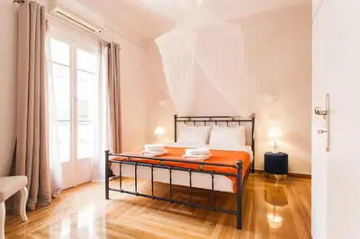 a bedroom with a bed and a large window at Splendid Full 5BDR/3bath/2kitchens Mansion in ATH in Athens