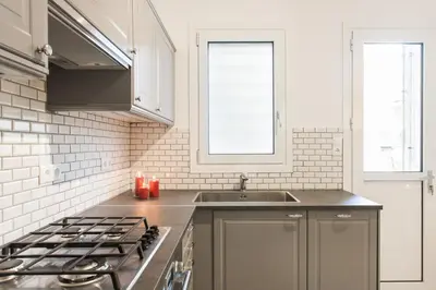 a kitchen with a sink and a stove top oven at HIGHEND 2BDR Full APT/ IDEAL LOCATION (and Netflix) in Athens