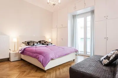 a bedroom with a bed with a purple blanket at HIGHEND 2BDR Full APT/ IDEAL LOCATION (and Netflix) in Athens
