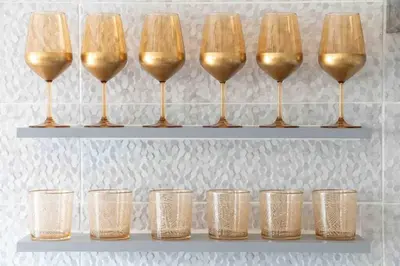 a row of wine glasses on a shelf at 2BDR Boutique Full Apt in Plaka (BIG BALCONY) in Athens